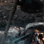 Survival Strategies - A campfire with a kettle and a kettle