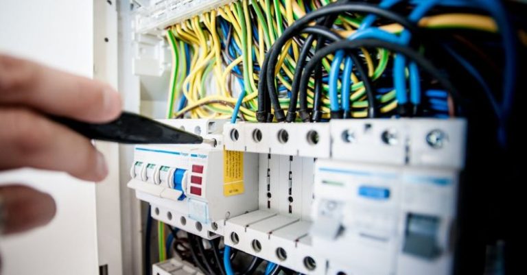Server Maintenance - Electrician Fixing an Opened Switchboard