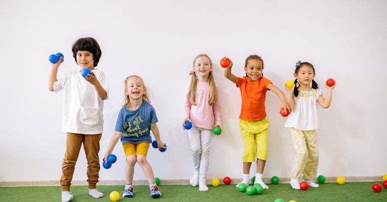 Latest Games - Little Girls and Boys Having Fun Playing With Colorful Balls