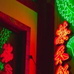 Highlight Reels - From below of illuminated sign with bright Chinese hieroglyphs hanging outside building at night