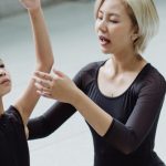 Beginners - Asian ballet instructor and girl practicing movements on floor